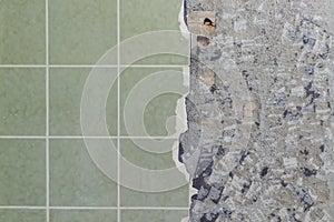 Bathroom tiles wall besides cracked and destroyed undersurface