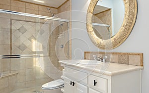 Bathroom with tub shower and glass doors