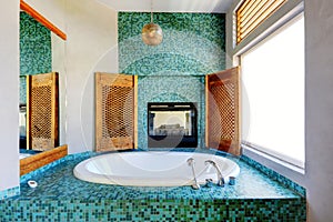 Bathroom turquoise tile wall trim with fireplace