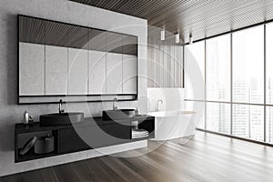 Bathroom with two black sinks with mirror and white bathtub near window