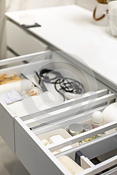 Bathroom under sink organizer drawers with neatly placed bath amenities and toiletries.