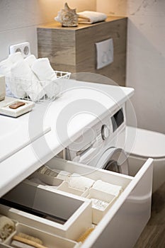 Bathroom under sink organizer drawers with neatly placed bath amenities and toiletries.