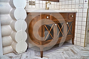 Bathroom vanity cabinet with acrylic countertop in luxury bathroom. Country style. Details furniture