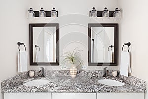 A bathroom with a white cabinet and marble countertop.