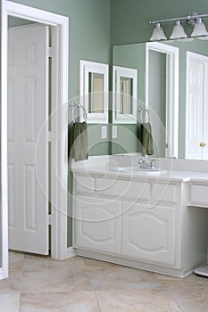 Bathroom with white cabinets and trim