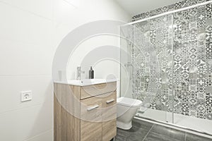 bathroom with white porcelain sanitaryware, shower cabin with