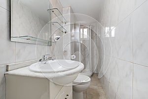 bathroom with white porcelain sink on marble countertop, square