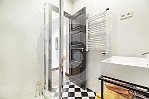 Bathroom with white porcelain sinks, shower cabin with glass partition