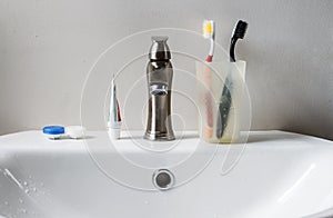 Bathroom white sink, faucet and hygienic set