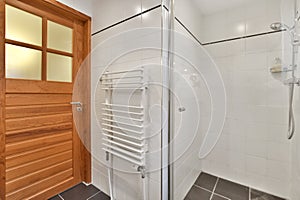 a bathroom with a shower and a wooden door photo