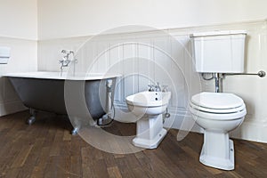 Bathroom with white walls and large black bathtub