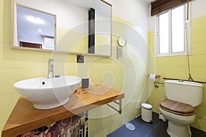 Bathroom with wood-framed mirror, solid wood plank top, white porcelain