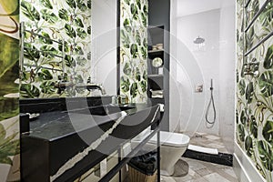 Bathrooms with one-piece black marble sinks with white veining photo