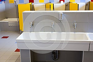 Bathrooms of a school for children with low ceramic sinks