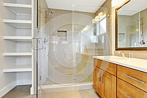 Bathroon interior with vanity cabinet, two sinks and opened glass shower door