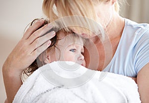 Bathtime cuddles. a baby being cuddled by her mother after a bath.