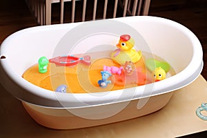Bathtub with ducks and other toys for babies