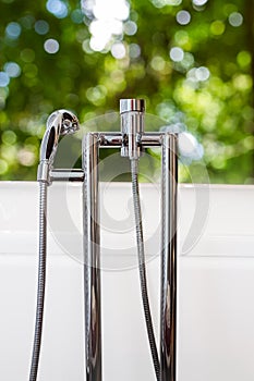 Bathtub faucet with green background