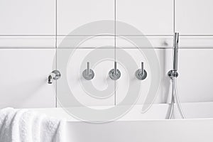 Bathtub faucet in white wall