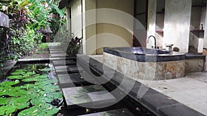 Bathtub in a tropical garden under the open sky