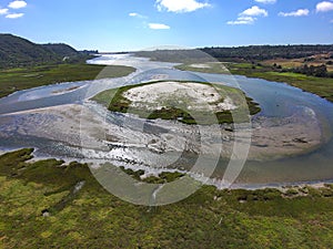 Batiquitos Lagoon with blue waters, lush green trees and blue sky background with clouds photo