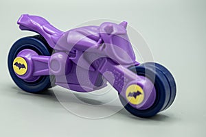 bycycle. plastic toy violet bycycle. batman batcycle isolated on gray background. plastic batman batcycle. photo
