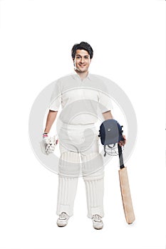 Batsman holding a cricket bat with sports helmet and smiling