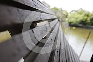 The battens are made of wood along the water`s edge.