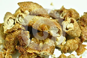 Batter fried pork innards with flour on white background