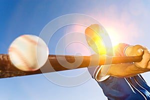 Batter Hitting Baseball on sunny day photo