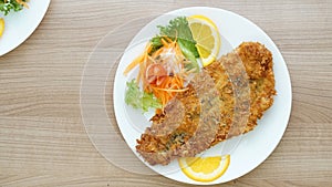 Battered fish steak with salad and vegetable