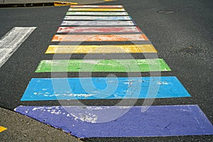 Battered gay-themed rainbow color crosswalk photo