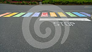 Battered gay-themed rainbow color crosswalk photo