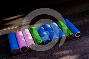 Batteries in `18650` format, on wooden background