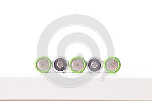 5 Batteries AA or LR6 are lying on the white table