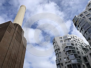 Battersea Power Station, London, UK. Old fashioned chimneys against modern new build architecture against one other