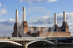 Battersea Power Station on the River Thames with a passing railway train showing public transport infrastructure
