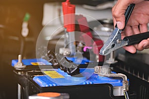 Battery charging cables transferring power , Man calling to car Mechanic service.