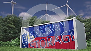 Battery container with flag of the Philippines and ENERGY STORAGE text at wind turbines. Ecological electric power