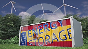 Battery with flag of Spain and ENERGY STORAGE text at wind generators. Renewable power concept. 3d rendering