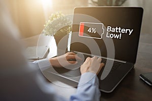 Battery low message on mobile device screen. Internet and technology concept.