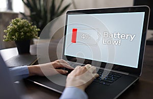 Battery low message on mobile device screen. Internet and technology concept. photo