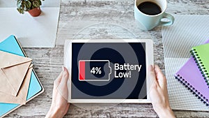 Battery low message on mobile device screen. Internet and technology concept.