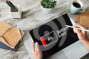 Battery low message on mobile device screen. Internet and technology concept.