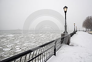 Battery Park under snow with frozen Hudson River, New York