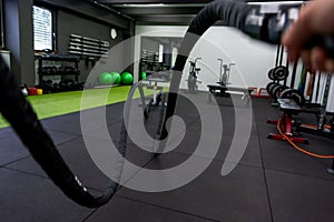 Battle rope training in gym - first person point of view.