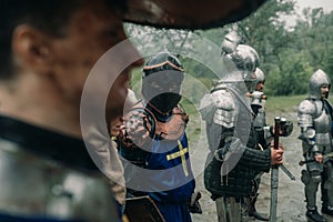 Battle squad of medieval knights of the Crusaders stand with their swords