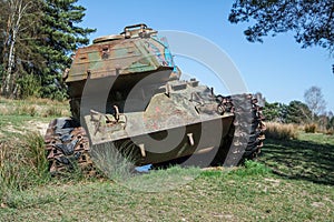 Battle tank in a moor between two forests
