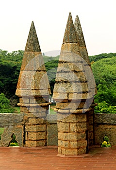 The battlement of bangalore palace with trees.