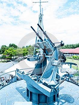 Battleship machine gun against a blue cloudy sky